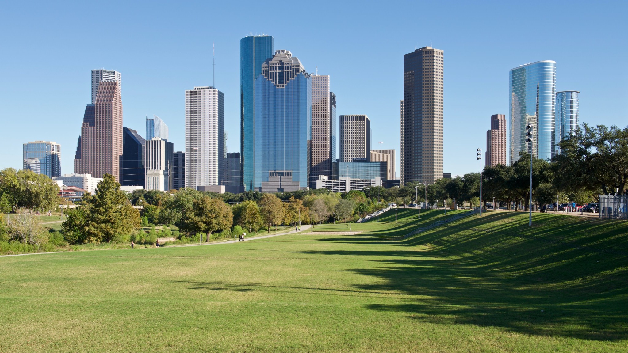 Downtown Houston skyline viewed across Buffalo Bayou Park on a clear day